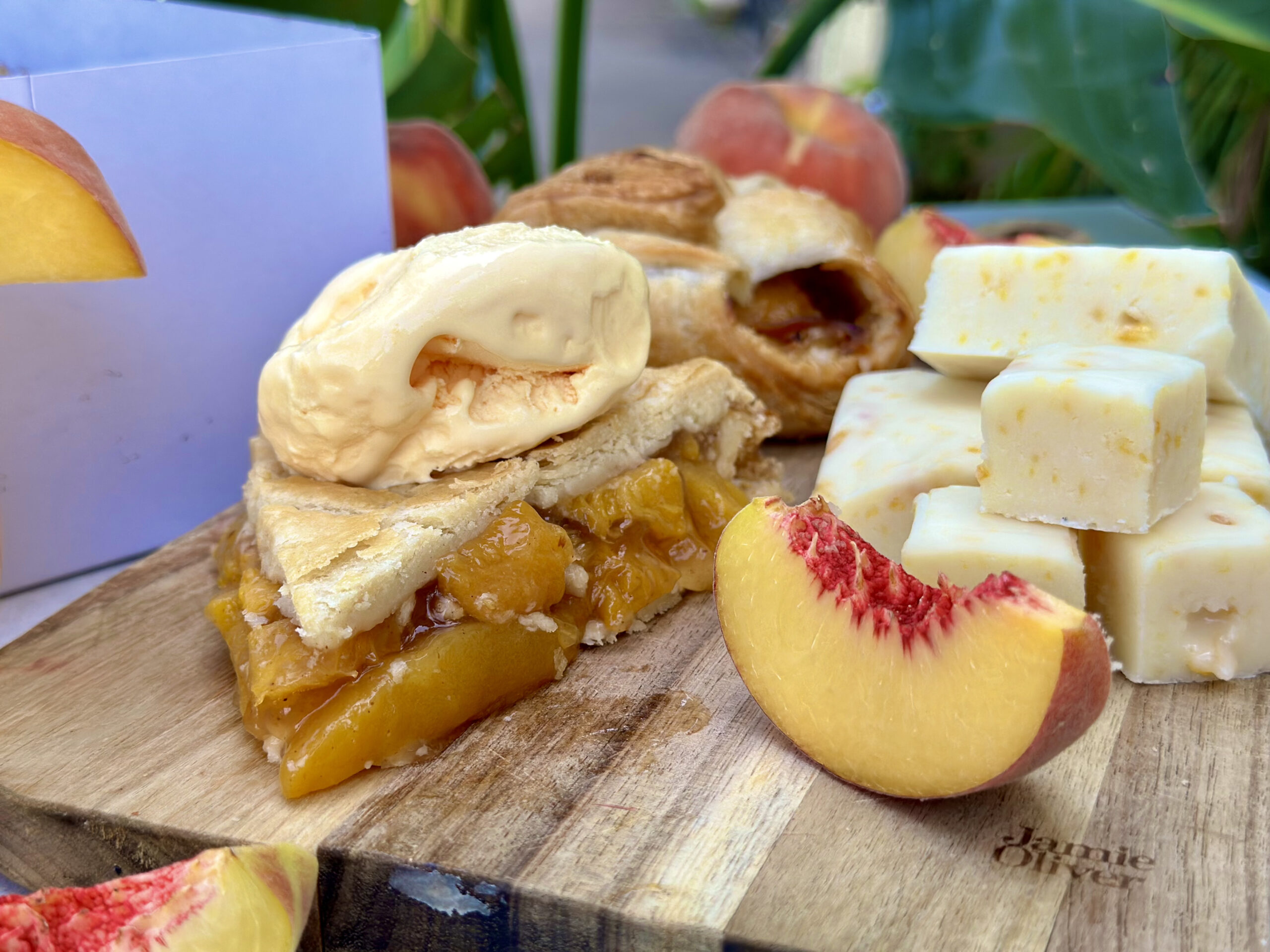 Peach slice with peach pie and ice cream next to it