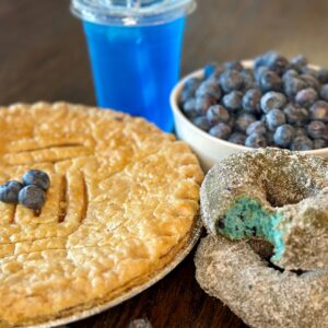 Blueberry pie, donuts, lemonade by bowl of fresh blueberries