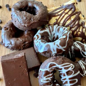 Assorted chocolate pastries with chocolate dripped on