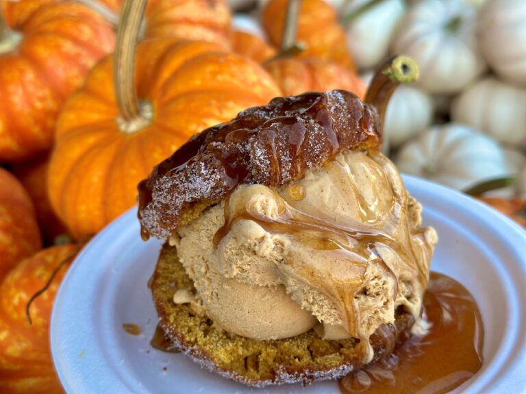 A pumpkin ice cream sandwich on top of pumpkins